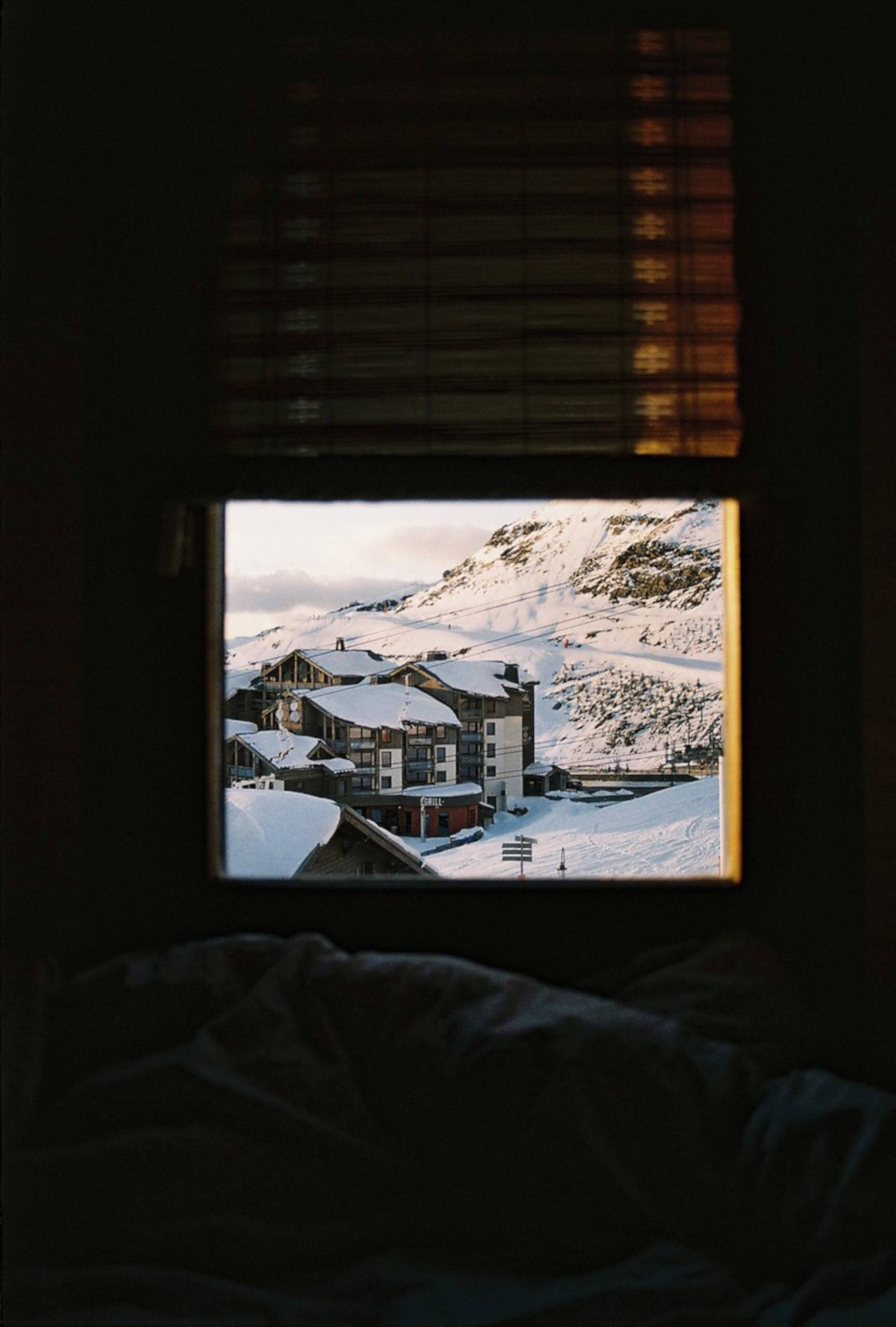 photo of a snowy cabin through the window